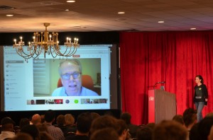 VFX Supervisor Scott Squires, on screen, participates in the VFX Town Hall: COLLIDER 2013 event via Google+ Hangout. At right is Town Hall moderator Mariana Acuna Acosta.